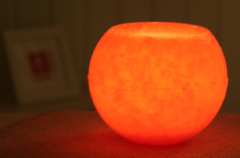 Wachswindlicht, rund, ca. 12 cm Ø, orange